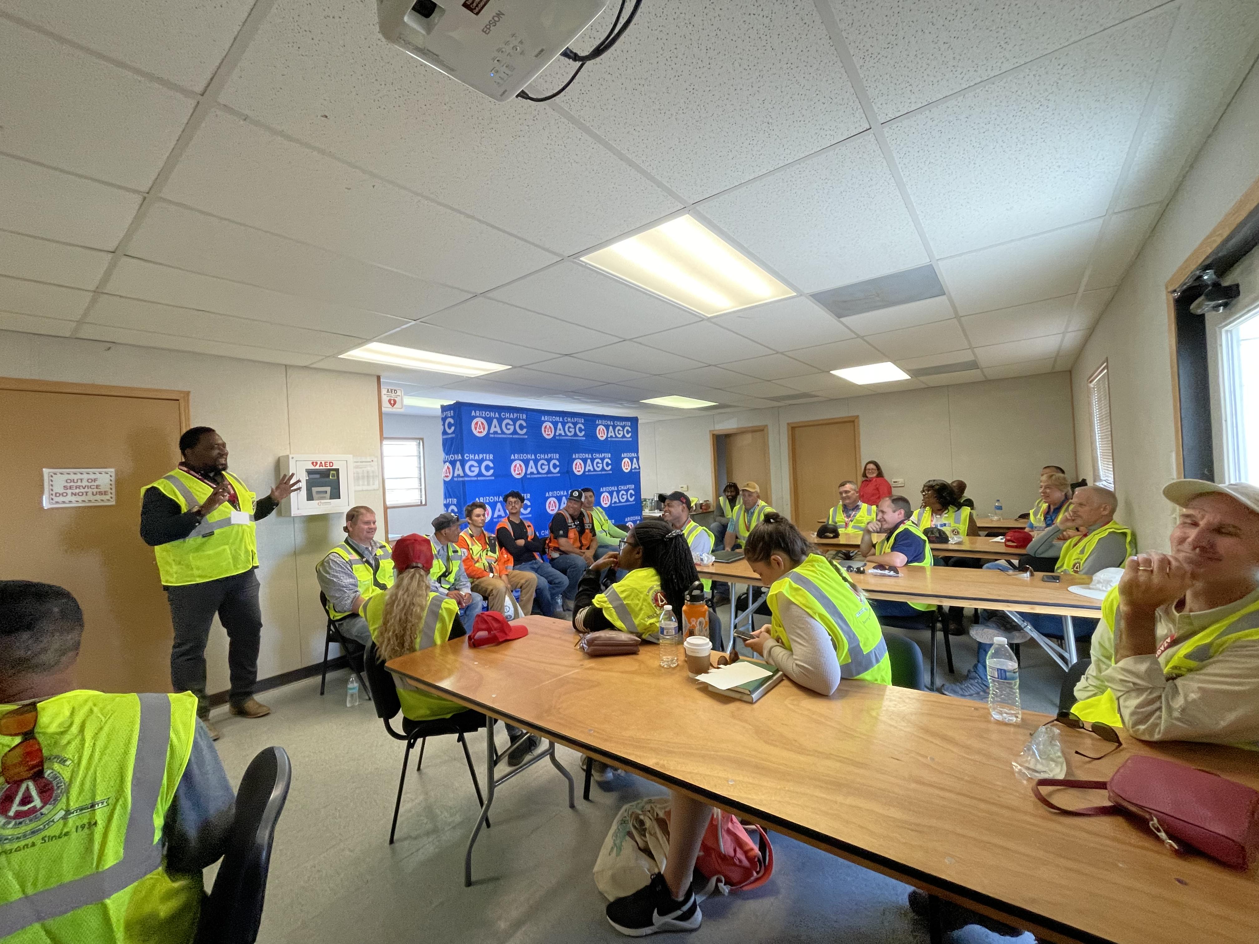 People in safety gear in a classroom setting.